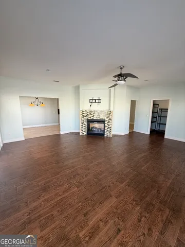 a view of empty room with furniture and a ceiling fan