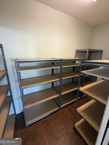 a view of room with wooden floor and windows