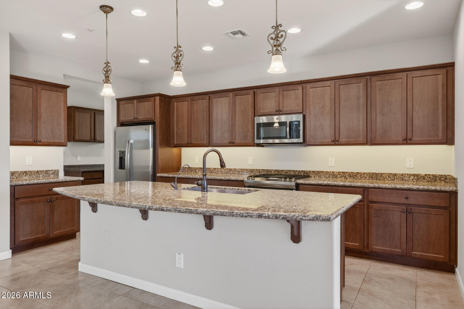 17963 East Silver Sage Lane Rio Verde, AZ 85263 - Photo 11 of 75 a kitchen with kitchen island a sink stainless steel appliances and cabinets