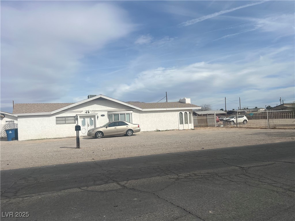 View of front of house with stucco siding, a chimn