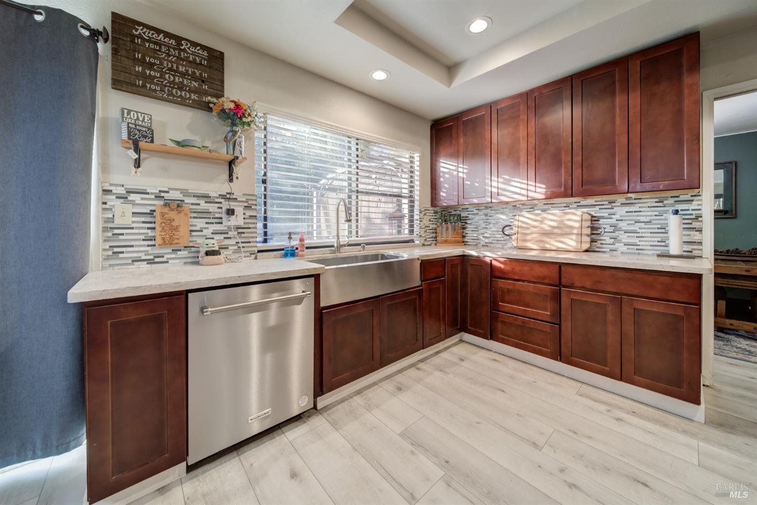 989 Suffolk Way Fairfield, CA 94533 - Photo 3 of 30 a kitchen with stainless steel appliances granite countertop a sink dishwasher stove and cabinets with wooden floor