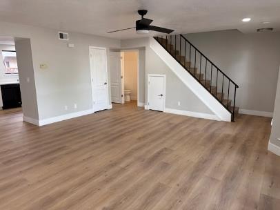 31 West 6th Street, Unit 1 Tracy, CA 95376 - Photo 3 of 12 a view of a hallway with wooden floor and staircase