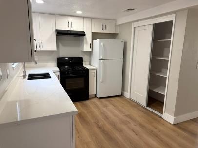 31 West 6th Street, Unit 1 Tracy, CA 95376 - Photo 5 of 12 a kitchen with a refrigerator and a stove