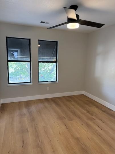 31 West 6th Street, Unit 1 Tracy, CA 95376 - Photo 8 of 12 a view of an empty room with window and wooden floor