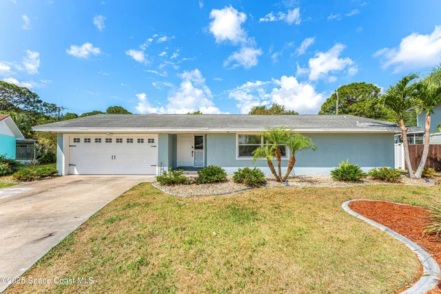 a front view of a house with a garden and patio