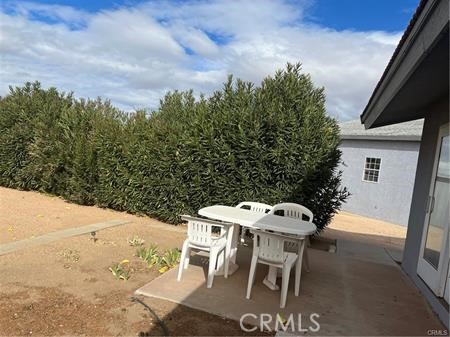 6818 Kittyhawk Avenue Hesperia, CA 92345 - Photo 13 of 14 a terrace with a table and chairs