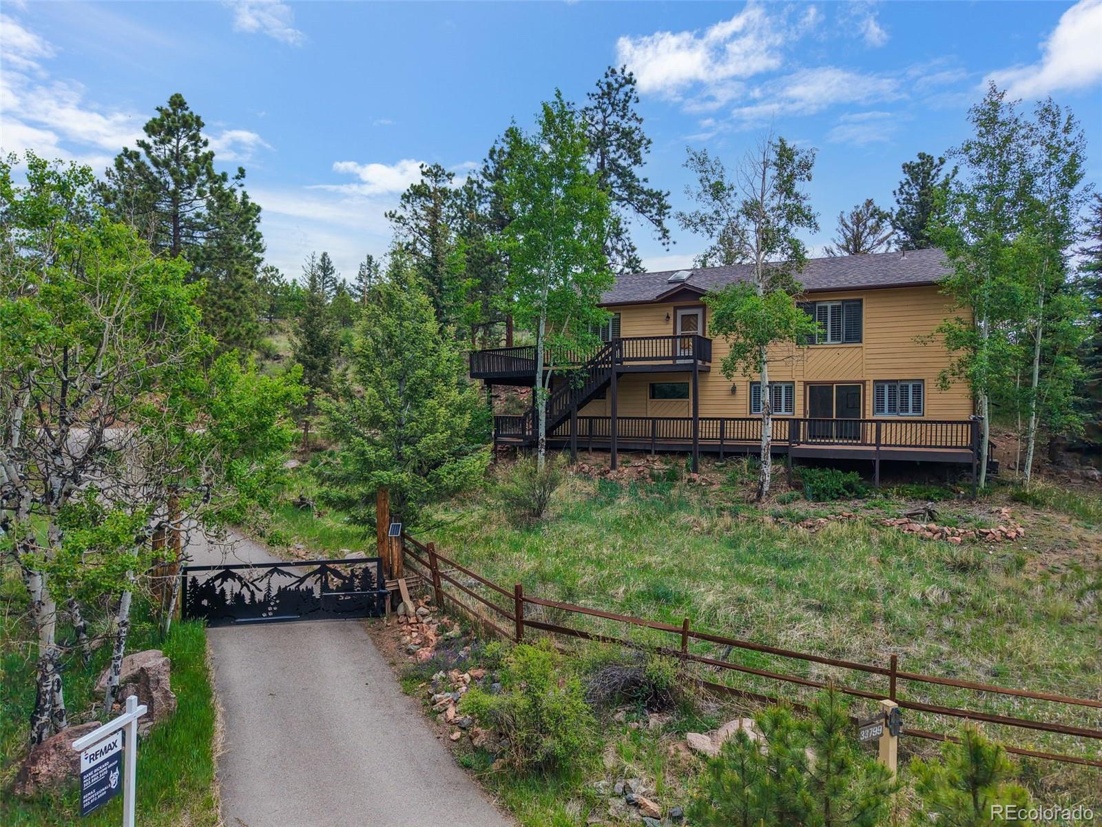 33799 Warren Road Pine, CO 80470 - Photo 44 of 50 a view of a house with a backyard and sitting area