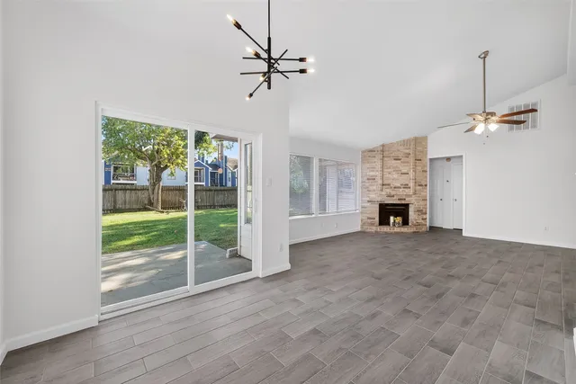 a kitchen with granite countertop cabinets stainless steel appliances and a wooden floor