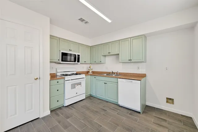 a kitchen with a sink stove and microwave