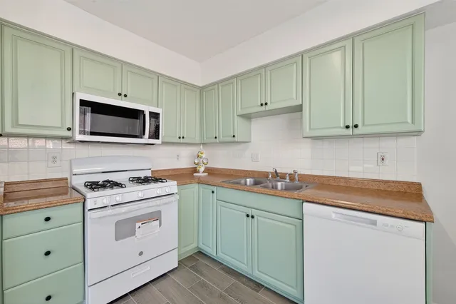 a kitchen with granite countertop cabinets and steel stove top oven