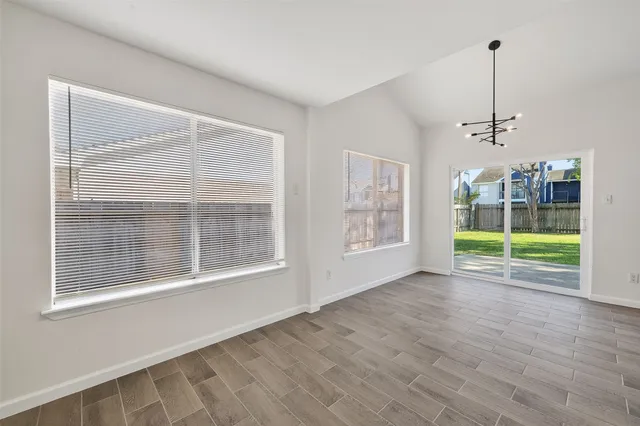a kitchen with a stove and a wooden floors