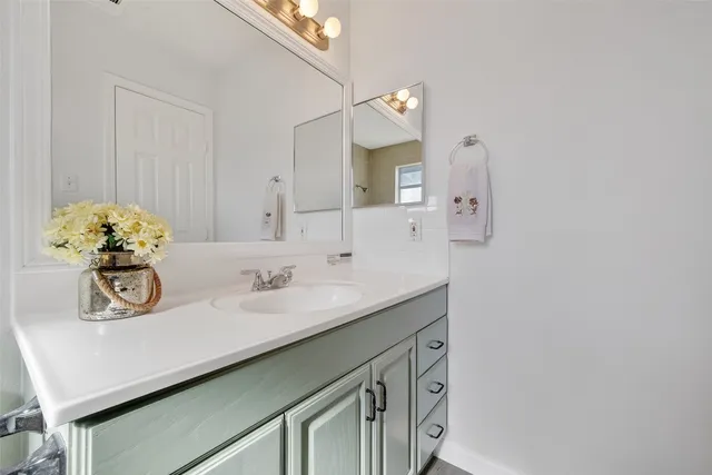 a bathroom with a toilet a sink a tub and mirror