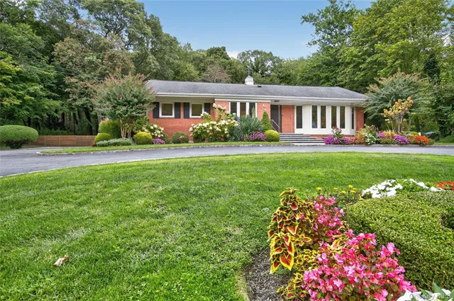 a front view of house with yard and trees