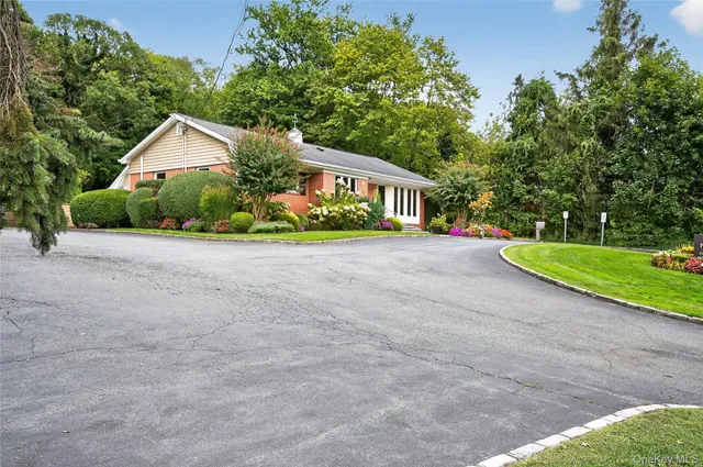 a front view of house with yard and green space