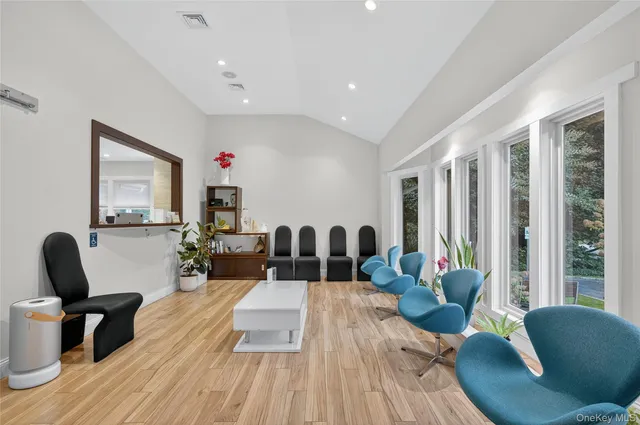 a living room with furniture kitchen view and a large window