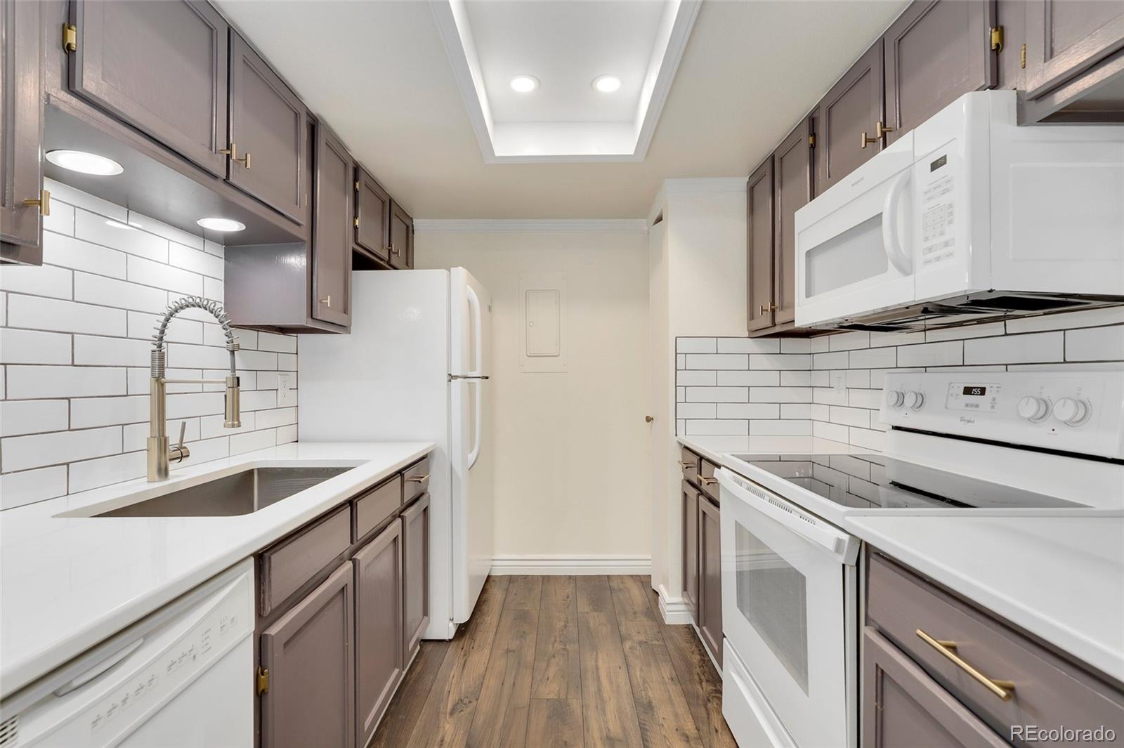 8335 Fairmount Drive, Unit 1202 Denver, CO 80247 - Photo 11 of 28 a kitchen with stainless steel appliances granite countertop a sink stove and refrigerator