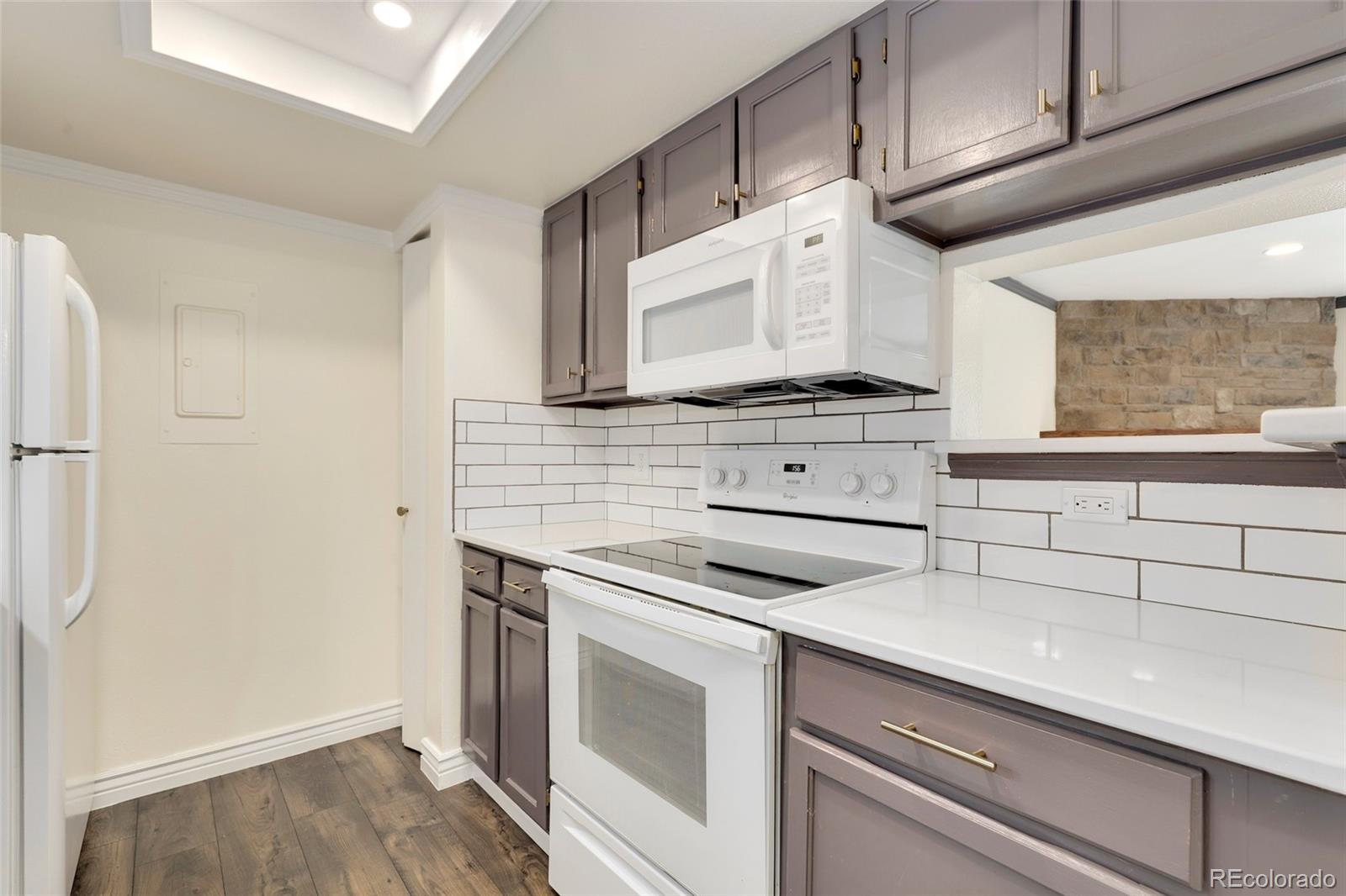 8335 Fairmount Drive, Unit 1202 Denver, CO 80247 - Photo 13 of 28 a kitchen with granite countertop cabinets stainless steel appliances and sink