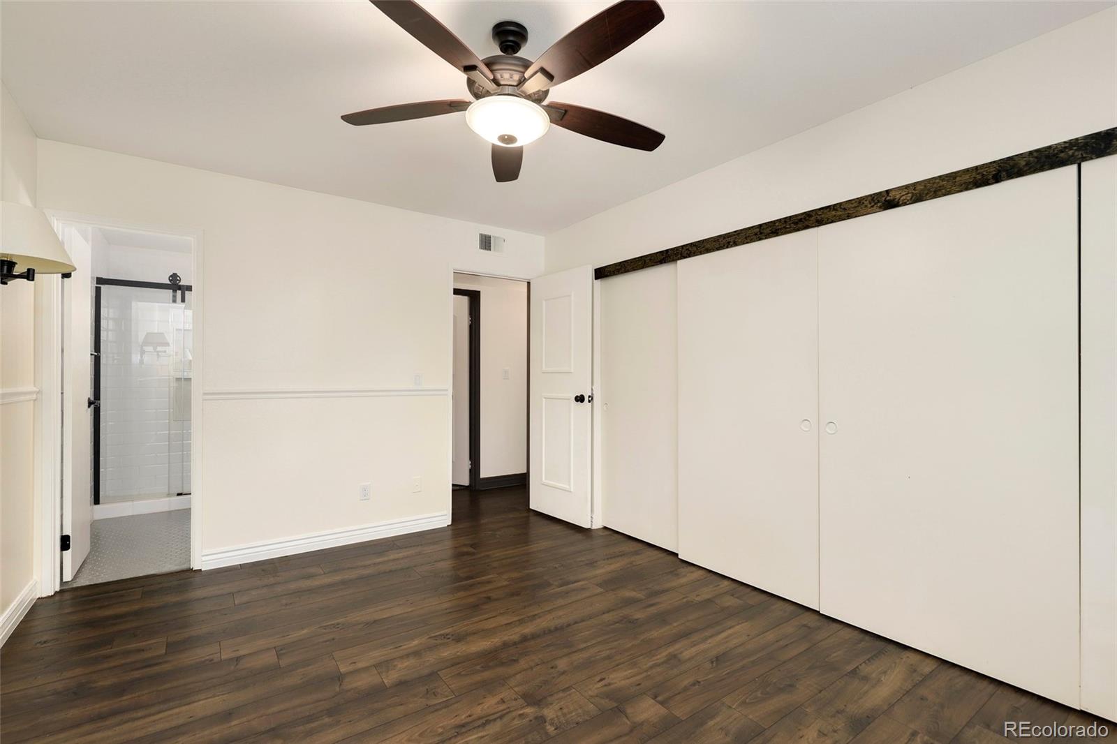 8335 Fairmount Drive, Unit 1202 Denver, CO 80247 - Photo 15 of 28 a view of an empty room with wooden floor