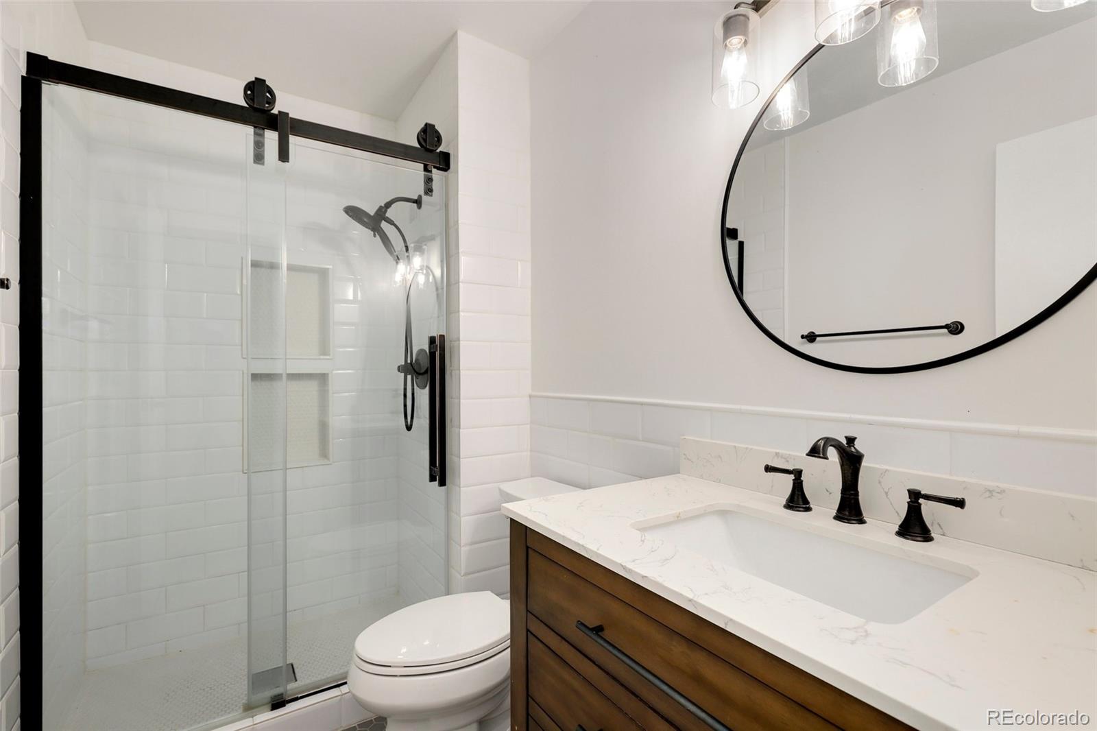 8335 Fairmount Drive, Unit 1202 Denver, CO 80247 - Photo 16 of 28 a bathroom with a sink toilet and shower