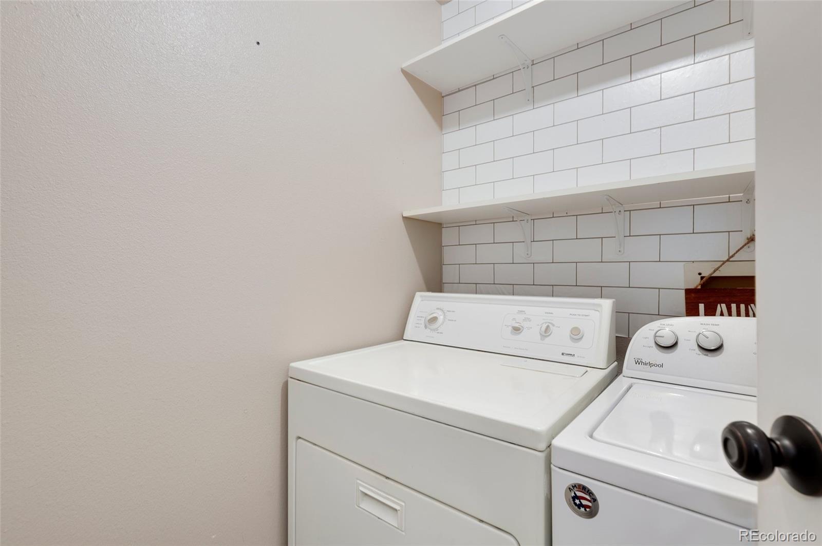 8335 Fairmount Drive, Unit 1202 Denver, CO 80247 - Photo 20 of 28 a utility room with dryer and washer
