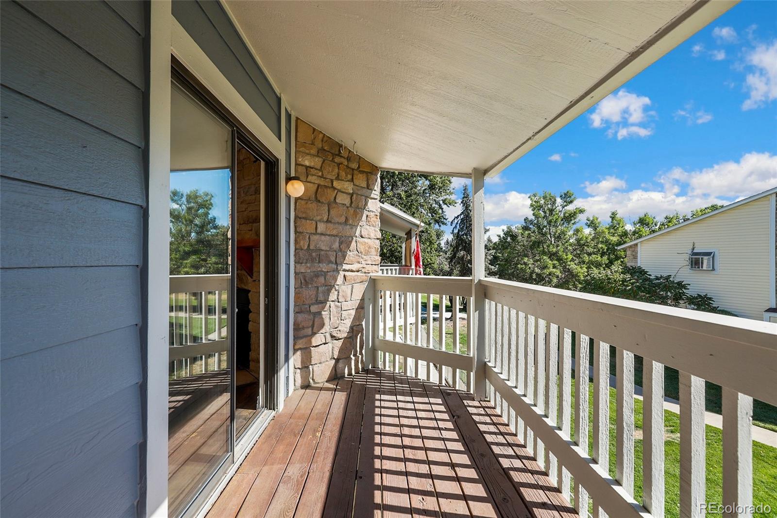 8335 Fairmount Drive, Unit 1202 Denver, CO 80247 - Photo 22 of 28 a view of a balcony with wooden floor