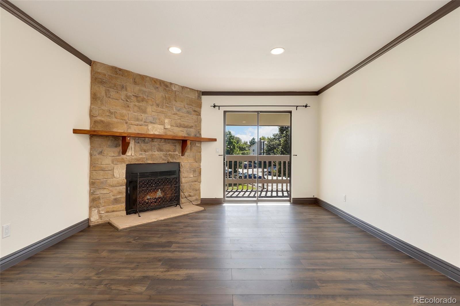 8335 Fairmount Drive, Unit 1202 Denver, CO 80247 - Photo 6 of 28 a view of an empty room with wooden floor and a window