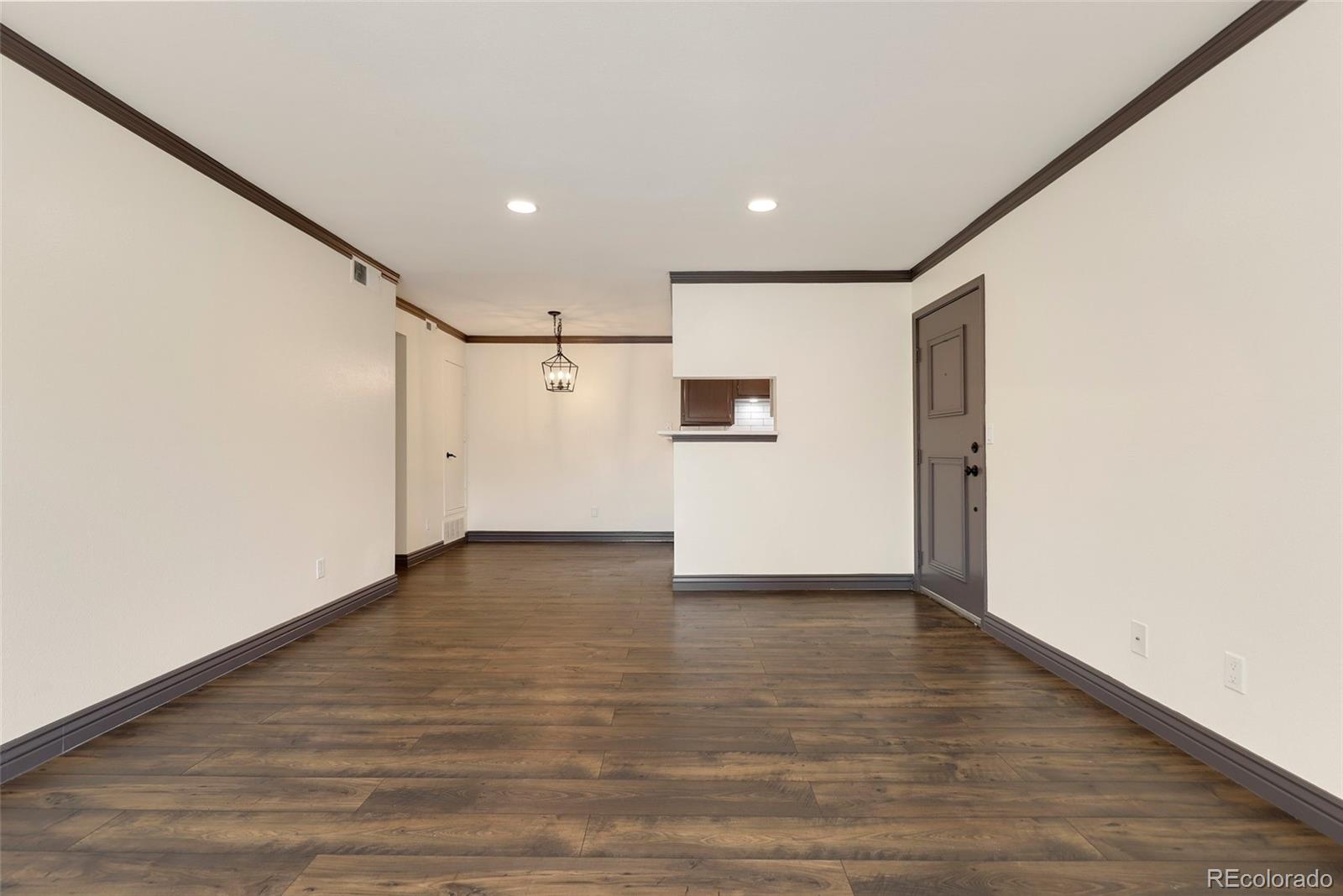 8335 Fairmount Drive, Unit 1202 Denver, CO 80247 - Photo 8 of 28 a view of empty room with wooden floor