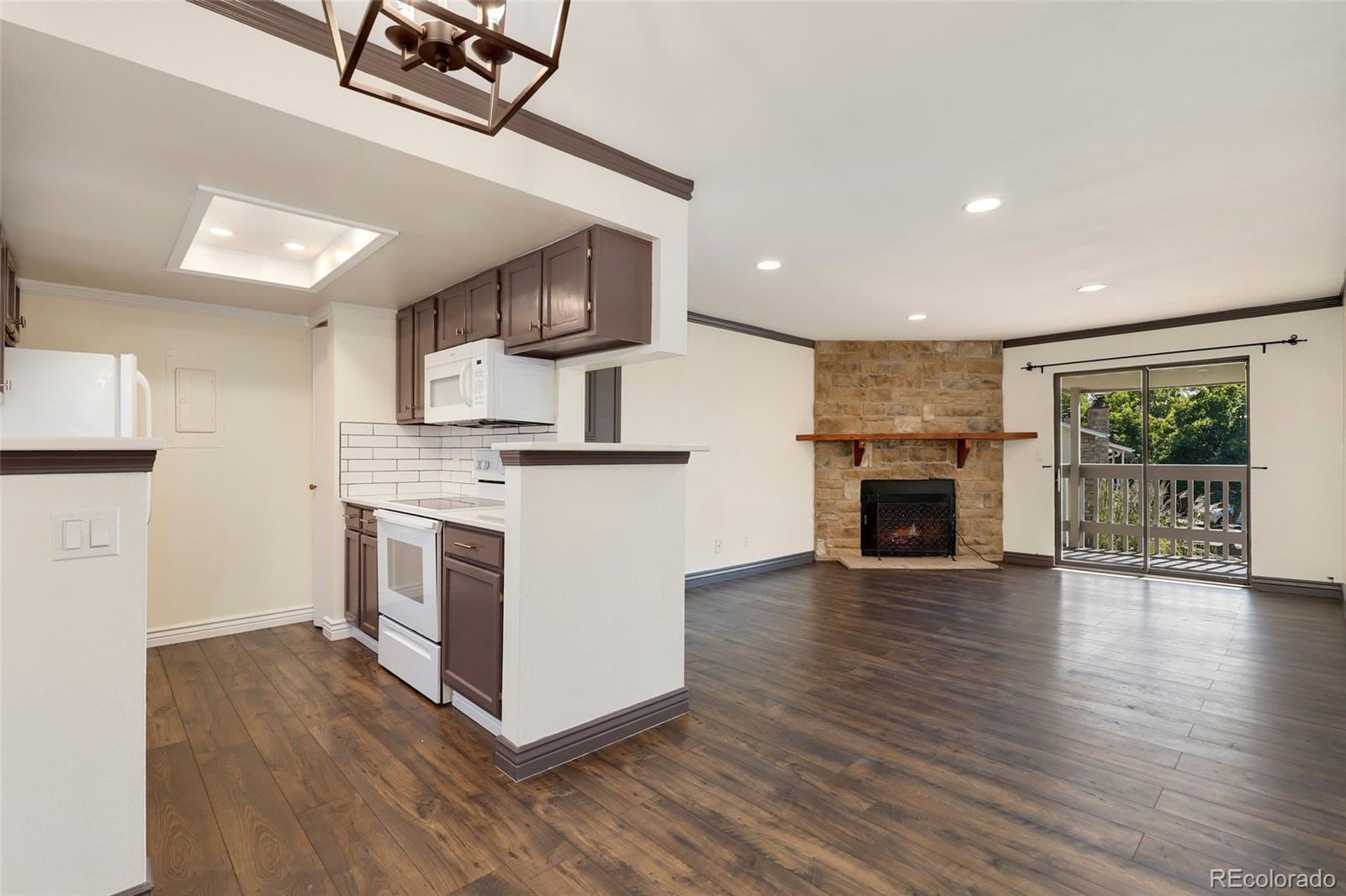 8335 Fairmount Drive, Unit 1202 Denver, CO 80247 - Photo 10 of 28 a view of kitchen with sink microwave and stove