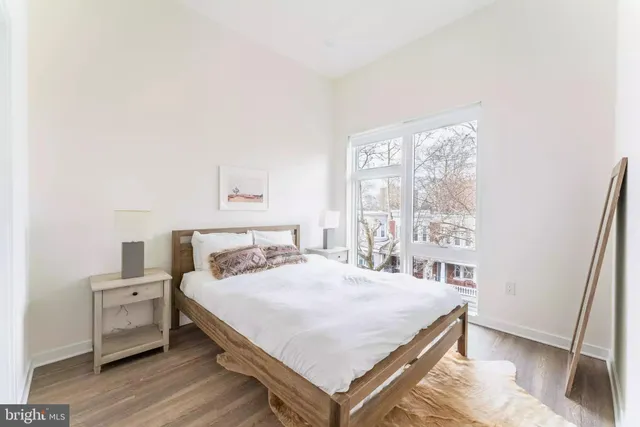 a bedroom with a bed and a large window