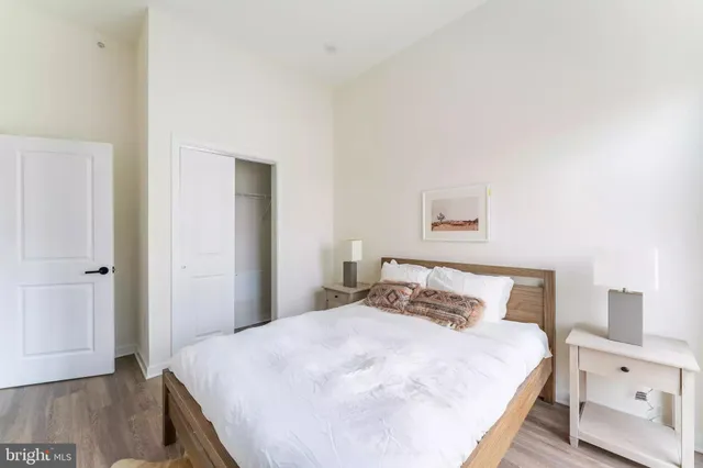 a bedroom with a bed and wooden floor