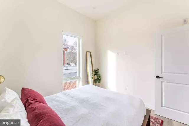 a bedroom with a bed and a window