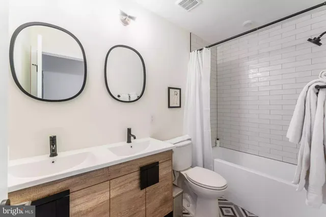 a bathroom with a sink a toilet and a mirror