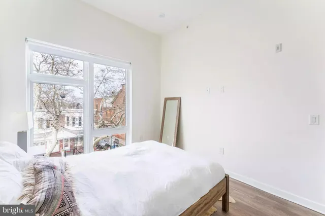 a bedroom with a bed and a window