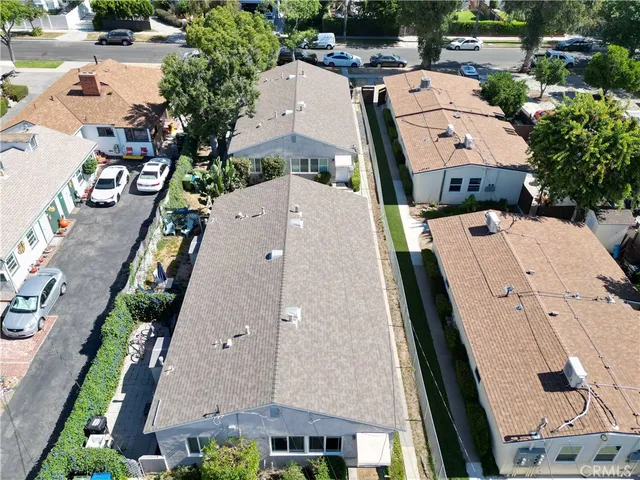 an aerial view of a house with a yard