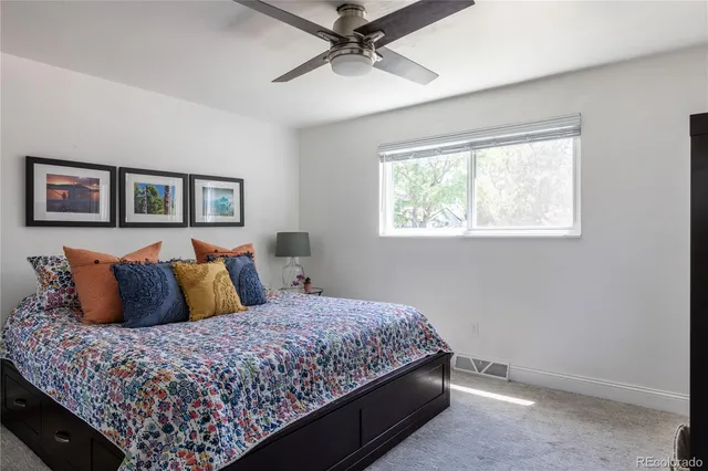 a bedroom with a large bed and a window