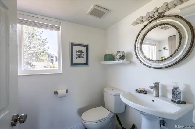 a white toilet sitting next to a bathroom sink