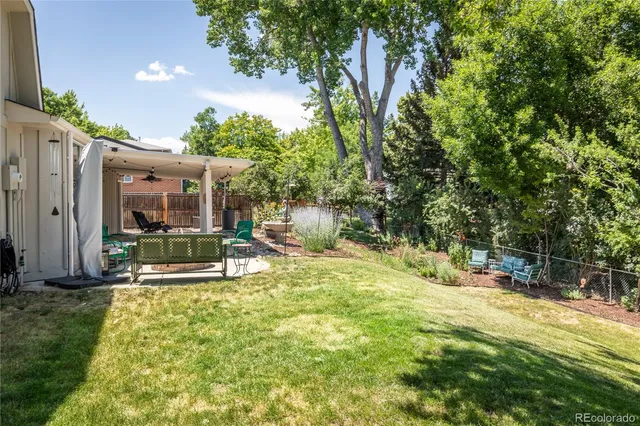 a building outdoor space with patio furniture and garden