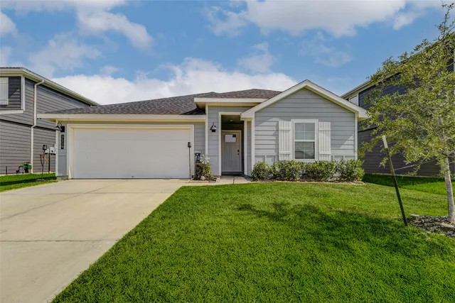 a front view of house with yard and green space