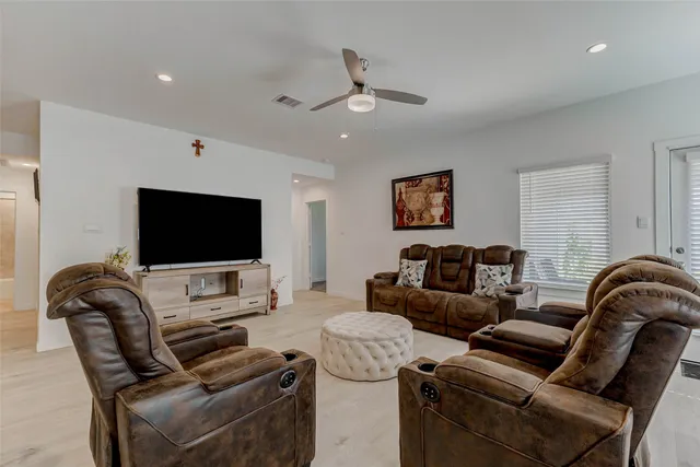 a living room with furniture and kitchen view