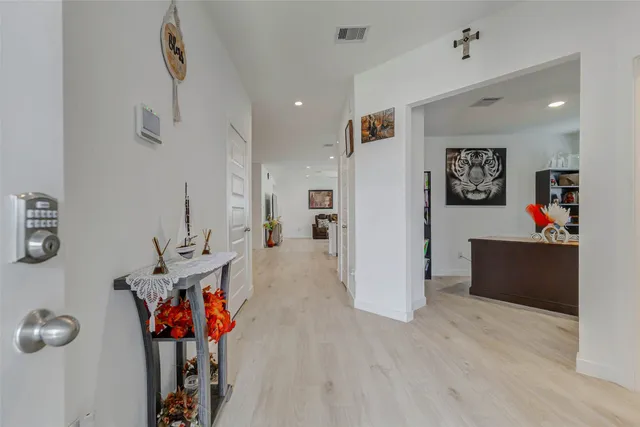 a view of a hallway with wooden floor