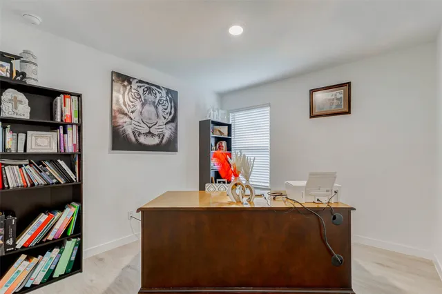a living room with furniture and a book shelf