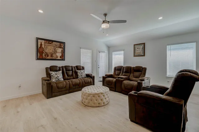 a living room with furniture and wall paintings