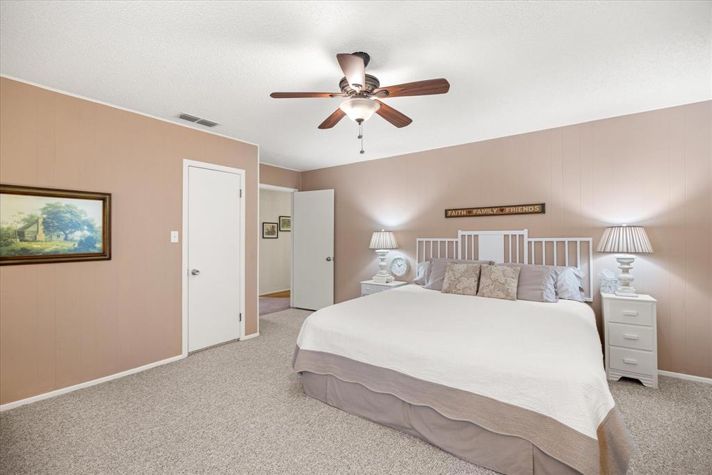 17305 Highway 281 Hico, TX 76457 - Photo 11 of 28 a bedroom with a bed and a chandelier
