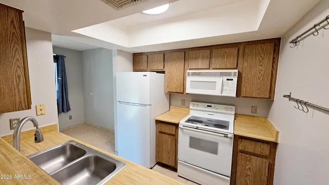 a kitchen with a refrigerator sink and stove