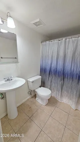 a white toilet sitting next to a bathroom sink