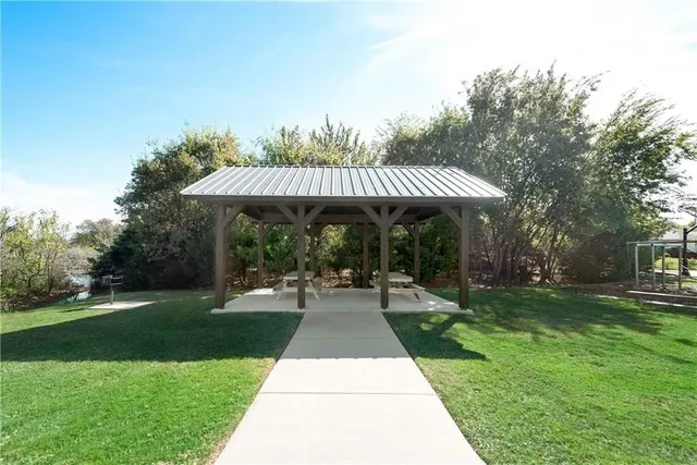 a view of a chairs and table in backyard