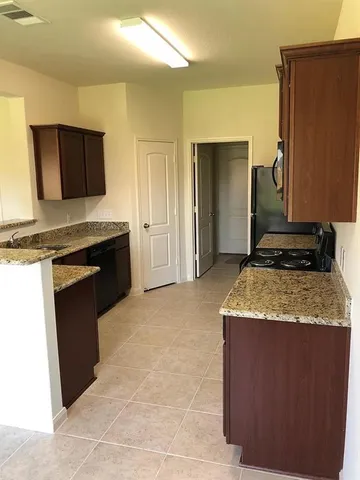 a kitchen with a stove top oven and sink