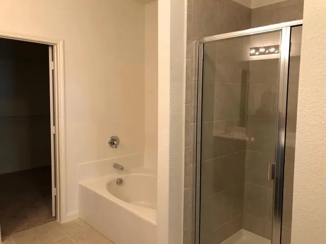 a bathroom with a bathtub and shower