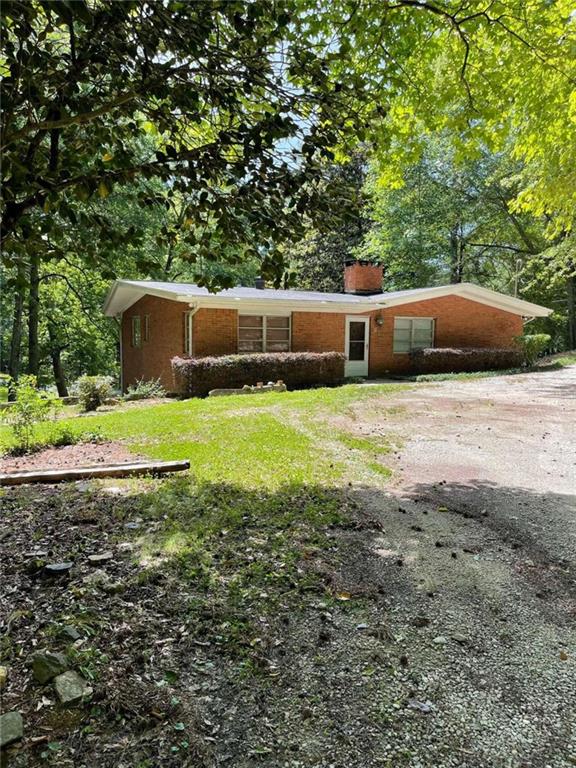 323 Mockingbird Lane Bremen, GA 30110 - Photo 1 of 1 a swimming pool with yard and trees in the background