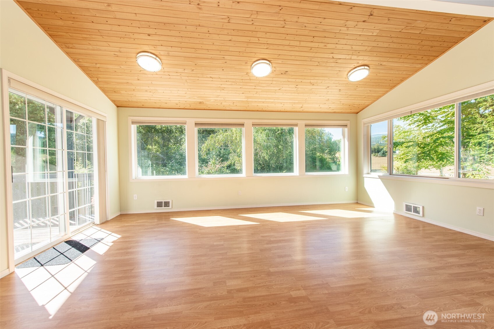 72 Skunk Hollow Road Sequim, WA 98382 - Photo 5 of 40 a view of an empty room with wooden floor and a window
